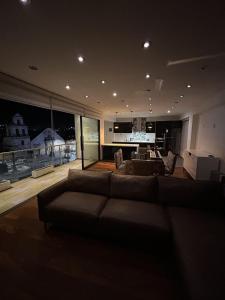 a large living room with a couch and a table at Luxury apartment with park views in Huancavelica
