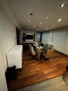 a large living room with a table and chairs at Luxury apartment with park views in Huancavelica +4 photos
