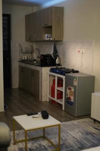 a kitchen with a stove and a table in it at Elite Escape in Muchatha +5 photos