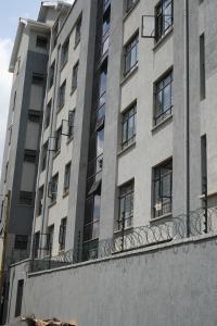 a tall building with windows and a balcony at Elite Escape in Muchatha