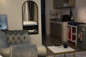 a living room with a couch and a mirror at Elite Escape in Muchatha
