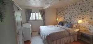 a small bedroom with a bed and a window at Family-friendly house near Söderåsen Natinal Park in Slättåkra