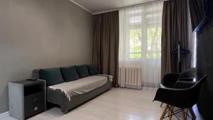 a bedroom with a bed and a large window at New 2 ROOM ultra centr in Bălţi
