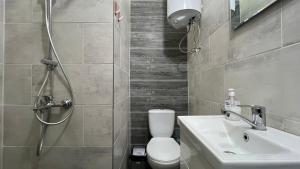 a bathroom with a shower and a toilet and a sink at New 2 ROOM ultra centr in Bălţi +10 photos