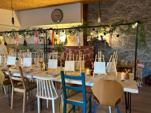 a dining room with a long table and chairs at La Villa Les Petits Gardons in Castillon-du-Gard