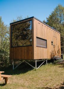 a tiny house on a stand in a field at Dvoye in Vodniki
