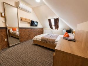 a hotel room with a bed and a mirror at Hotel Dolce Vita in Balatonkenese +87 photos