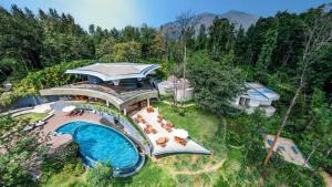 an aerial view of a house with a swimming pool at Java Rain Resort in Chikmagalūr