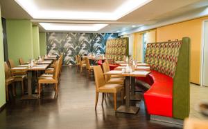 a dining room with tables and chairs in a restaurant at Ibercity Wien Schönbrunn in Vienna +57 photos