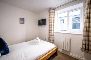 a small bedroom with a bed and a window at Morecambe Rooms in Morecambe