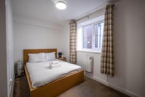 a bedroom with a bed with a window at Morecambe Rooms in Morecambe