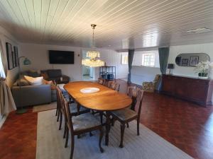 a dining room and living room with a table and chairs at Family-friendly house near Söderåsen Natinal Park in Slättåkra +17 photos