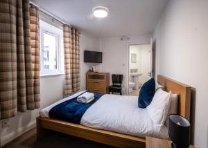 a bedroom with a bed and a desk and a television at Morecambe Rooms in Morecambe +6 photos