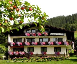 a building with flowers on the balconies of it at Hubertushof in Jungholz