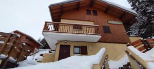 ein Gebäude mit Balkon im Schnee in der Unterkunft Parenthèse Alpine in La Plagne Tarentaise