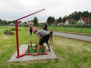 a man playing a game of mini golf in a park at Ferienhaus Deichgraf 65 im Feriend in Hollern-Twielenfleth