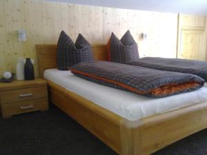 a bedroom with two beds with pillows on them at Landhaus Rossberg in Tannheim