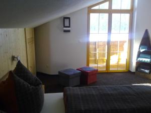 a living room with a bed and a window at Landhaus Rossberg in Tannheim +25 photos