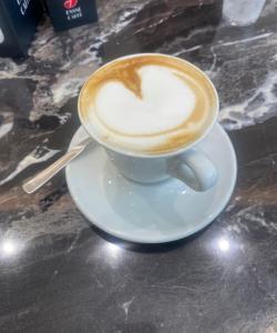 a cup of cappuccino on a plate on a table at Casa della Nonna Polignano a mare in Polignano a Mare +53 photos