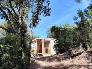 a house on a hill with trees at Camping 4 étoiles - Piscine - ccbfiee in Olmeto