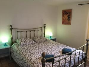Gites La Tourelle في Uxeau: غرفة نوم بها سرير ومصباحين على الطاولات
