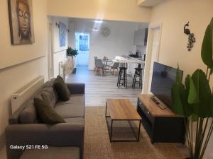 a living room with a couch and a table at Perfectspot in Tilbury