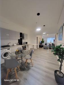 a kitchen and living room with a table and chairs at Perfectspot in Tilbury