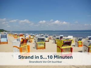 a group of chairs and tables on the beach at Haus Klipper - Nordseebad Burhave in Burhave