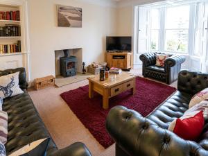 a living room with a couch and a coffee table at Edengrove in Aberfeldy