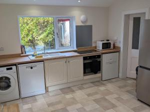 a kitchen with a sink and a microwave at Edengrove in Aberfeldy
