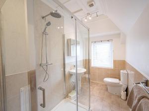 a bathroom with a shower with a toilet and a sink at Edengrove in Aberfeldy +27 photos