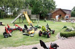 a group of childrens toys in a yard with a playground at Bauernhaus Wohnung 1 in Bojendorf +4 photos