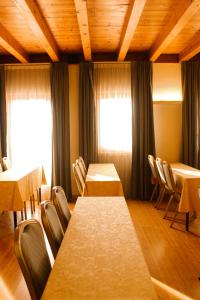 a conference room with tables and chairs and windows at Hotel Della Torre 1850 in Ponte San Marco