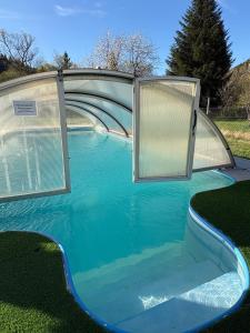 a pool of water with two sliding doors on it at Apartmán Šumava-Rejštejn in RejÅ¡tejn