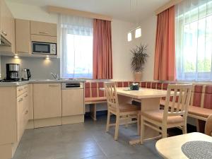 a kitchen and dining room with a table and chairs at Appartement Leiter in Niederthai