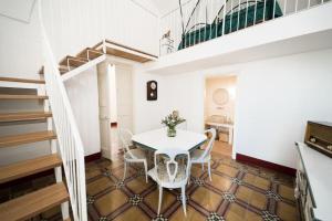 a room with a table and chairs and a staircase at Matinè Suite And Room in Matino