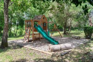 a playground with a slide and a play structure at Domaine du chemin Royale in Saint-Germain +23 photos