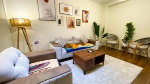a living room with a couch and a coffee table at luxurios hotel with pyramids view in Cairo