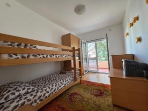 a bedroom with two bunk beds and a television at S Pearl Lux in Utjeha