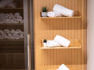 a shelf with towels and plants in a bathroom at Mercure Paris Bastille Marais in Paris +51 photos