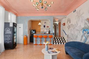 a living room with a blue couch and a bar at Blue Flamingo Suites in Miami Beach +28 photos