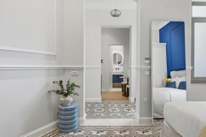 a living room with blue and white walls at Hospi Living Empire Suites in Heraklio