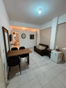 a living room with a table and a couch at Apartamento Rua Teresa in Petrópolis