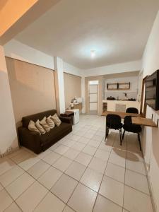 a living room with a couch and a table at Apartamento Rua Teresa in Petrópolis