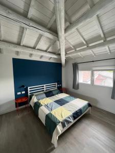 a bedroom with a large bed with a blue wall at Le Nogare in Abano Terme