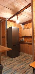 a kitchen with a stainless steel refrigerator and a table at Free People Camping in Vama Veche
