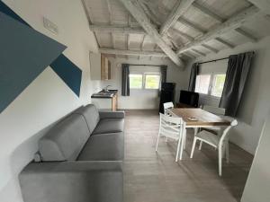 a living room with a couch and a table at Le Nogare in Abano Terme +10 photos