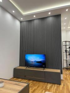 a living room with a flat screen tv on a wall at Lux Apartman Inđija in Inđija