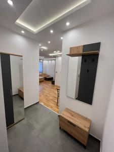 a room with a mirror on a wall at Lux Apartman Inđija in Inđija +3 photos