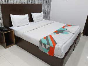 a bed in a room with at Hotel Siam International Karol Bagh New Delhi in New Delhi
